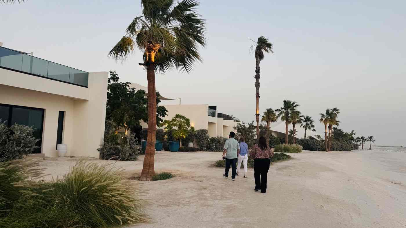 Family walking near the villas at dusk